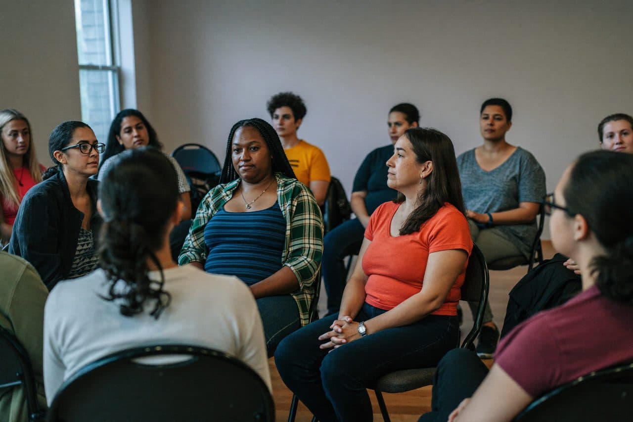 Community members listening as someone shares their story