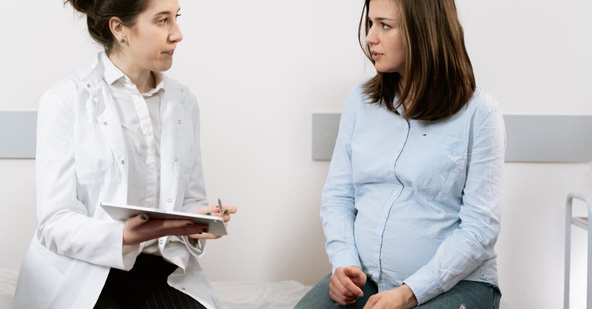 An expecting parent meeting with a care provider