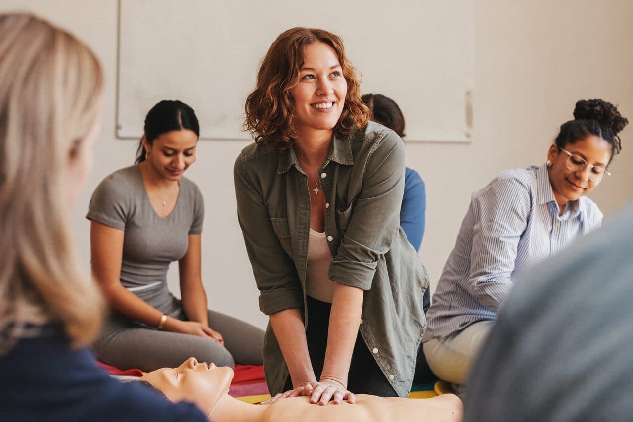 An instructor leading a hands-on CPR class