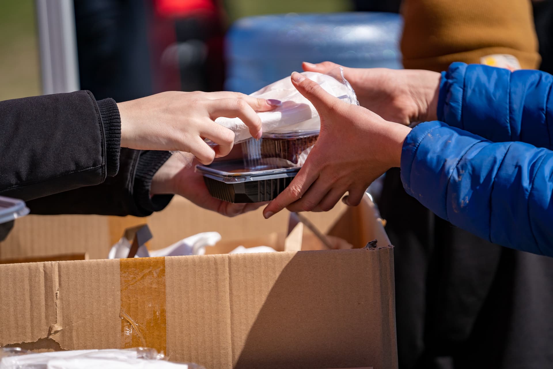 A volunteer sharing food with a neighbor