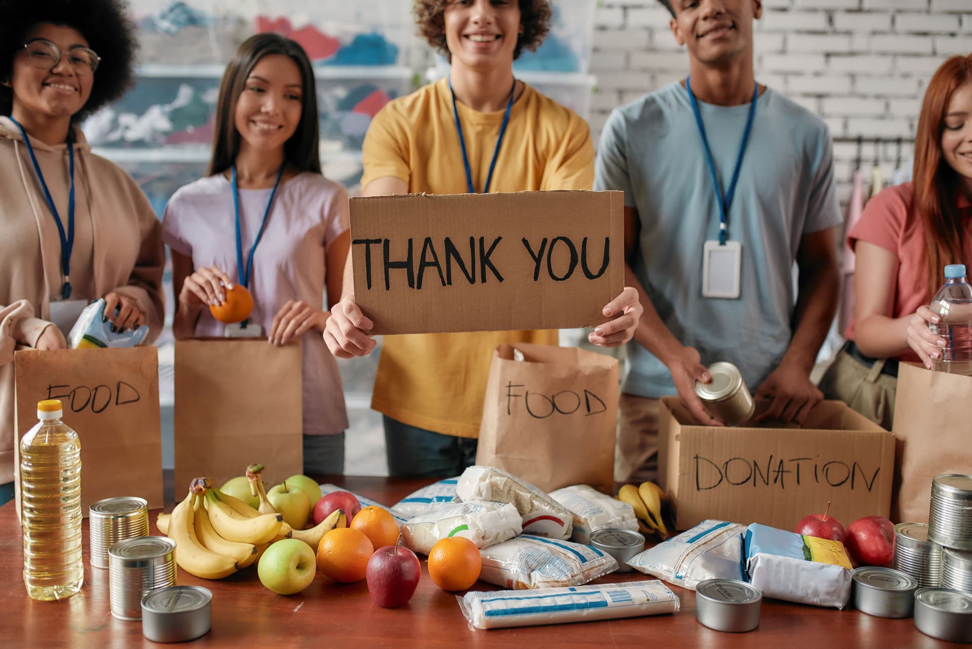 Volunteers holding a thank-you sign