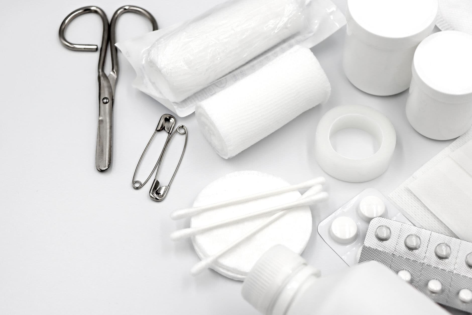 Emergency medical supplies: bandages, gauze, tape, scissors, and first-aid items