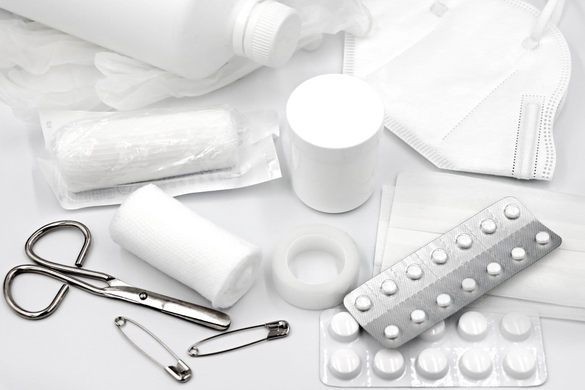 New, sealed medical supplies: gauze rolls, bandages, tape, masks, and gloves