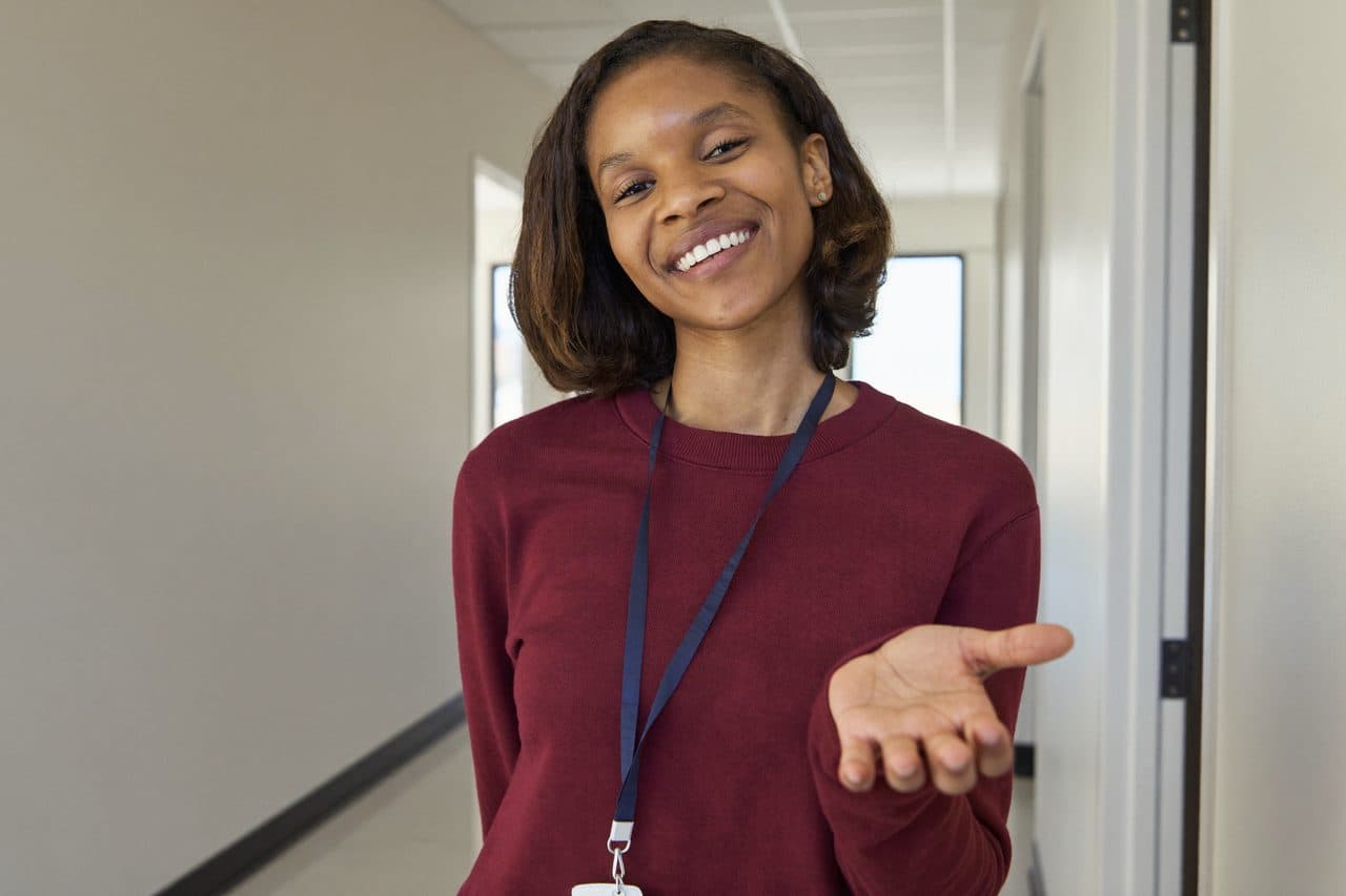 A friendly Daily Bread volunteer welcoming a visitor