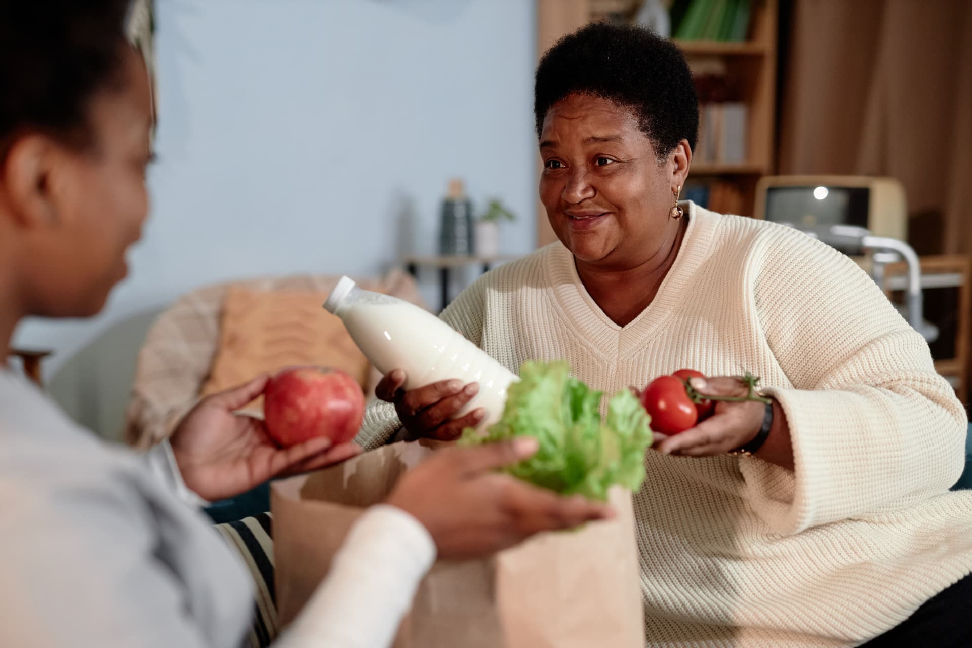 A neighbor receiving groceries at home